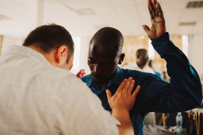 Praying for a man with the laying on of hands