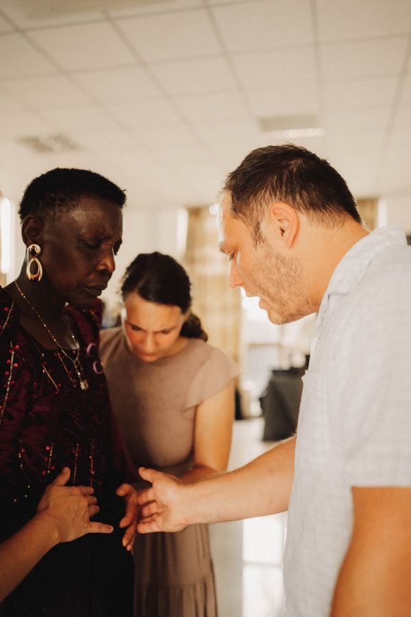 Praying with a woman during a ministry service