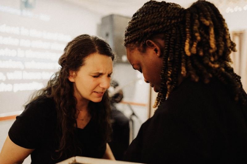 Two women praying together during a service